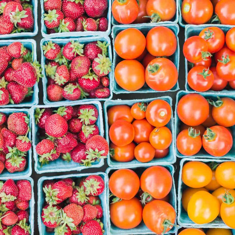 Tomatoes and strawberries in blue square cartons