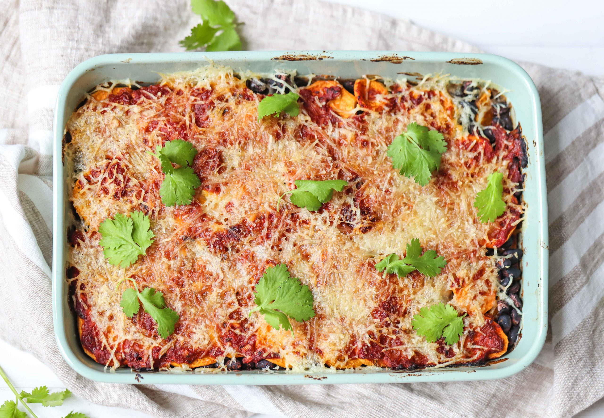 Sweet potato and black bean casserole in a white dish