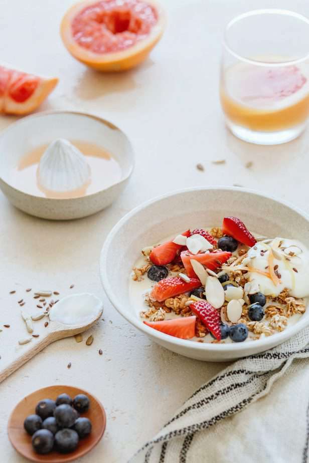 Bowl of cereal with fruit and nuts on top