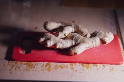 ginger root on a red cutting board