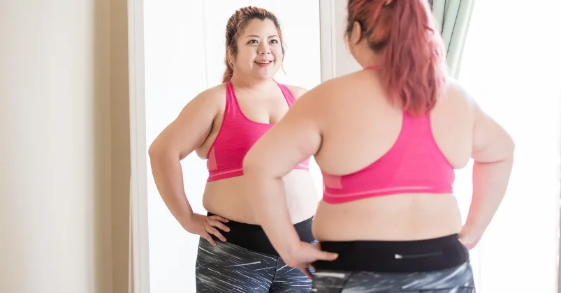 woman looking herself on mirror