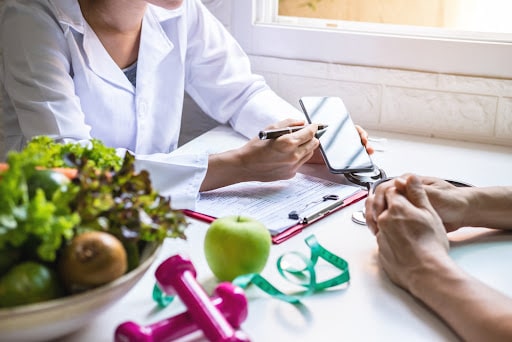 Nutritionist giving consultation to patient with healthy fruit and vegetable, Right nutrition and diet concept